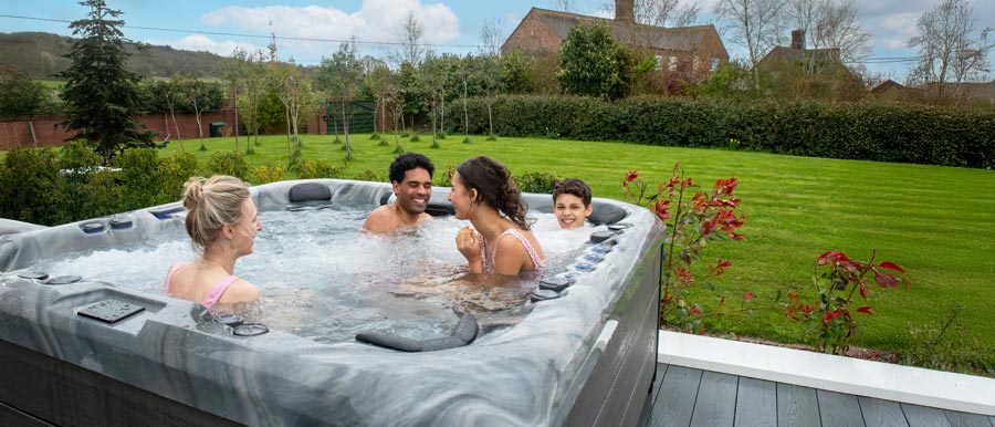 Family in hot tub overlooking garden