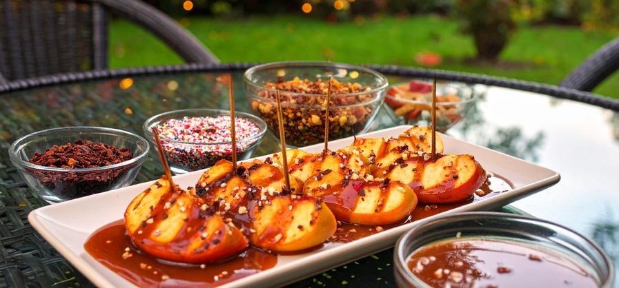 Grilled Apple slices covered in Toffee with sprinkles , nuts and chocolate